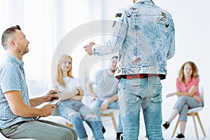 Teenager during group therapy session with professional therapist