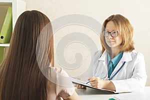 Teenager healthcare,patient at a doctor`s appointment in a medical office receives a consultation, passes tests, prescribes pills photo