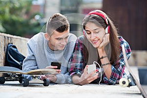 Teenager and his girlfriend with smartphones