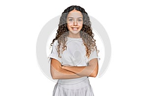 Teenager hispanic girl wearing casual white t shirt happy face smiling with crossed arms looking at the camera