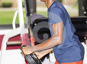 Teenager holding weights in a weightroom