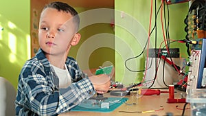 Teenager holds an electrical appliance in palm hand. LTE bulbs glow with light.