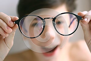 Teenager kid boy in myopia correction glasses photo