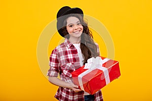 Teenager kid with present box. Teen girl giving birthday gift. Present, greeting and gifting concept. Happy teenager