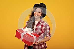 Teenager kid with present box. Teen girl giving birthday gift. Present, greeting and gifting concept. Happy teenager