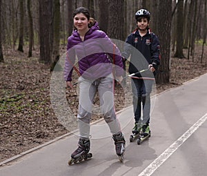 Teenager kids roller skating in the park