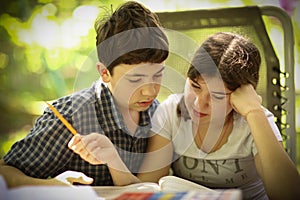 Teenager kids siblings sister help her brother with homework task