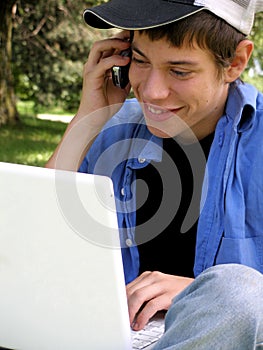 Teenager with a laptop and cellular