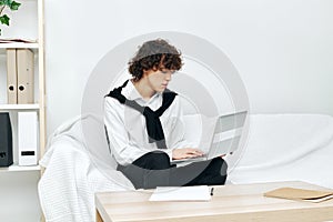 teenager laptop sitting on white sofa online training living room