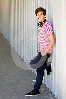 Teenager leaning against wall