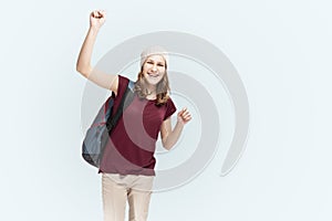 Teenager Lifestyle Ideas. Portrait Of Caucasian Laughing Teenager Girl With Teeth Brackets Posing With Backpack Over White