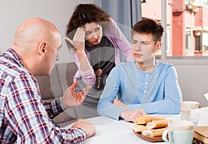 Teenager listening to reprimanding parents