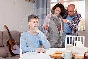 Teenager listening to reprimanding parents