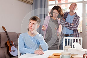 Teenager listening to reprimanding parents