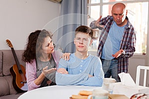 Teenager listening to reprimanding parents