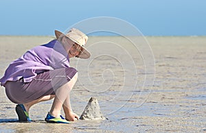 Teenager making sandcastles