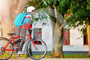 Teenager in the morning quickly riding on bicycle to the lesson.