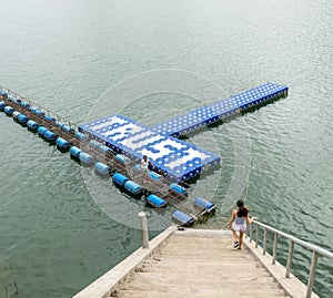 Teenager and mother at resevoir in Thailand