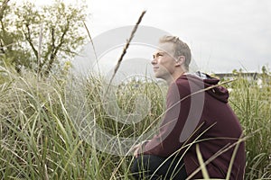 Teenager in open filed looking up to heaven