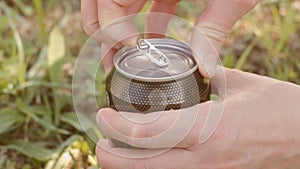 Teenager opens can with drink