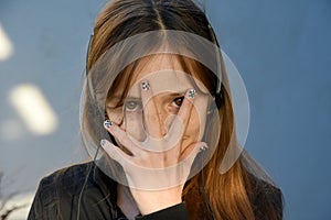 Teenager with painted fingernails and headphones