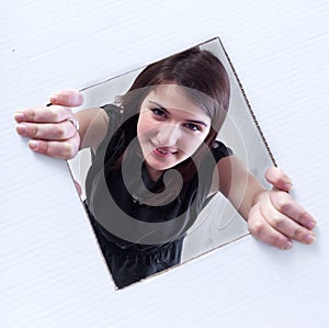 Teenager peeking out of a hole