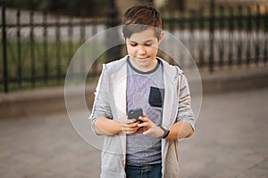 Teenager play games at mobile phone outside