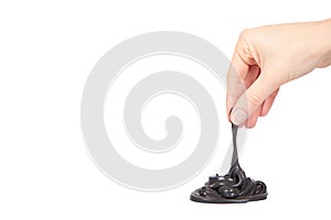 Teenager playing black slime with hand, transparent toy
