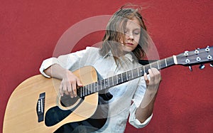 Teenager playing guitar in the street