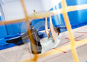 Teenager practicing alternate landings on trampoline