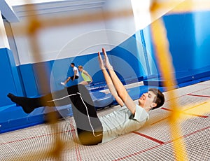 Teenager practicing alternate landings on trampoline