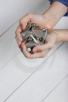 Teenager presenting used finger batteries in their palms, advocating for waste management