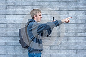 Teenager recording a video with his cellphone.