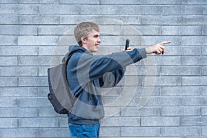 Teenager recording a video with his cellphone.