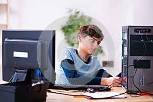 Boy reparing computers at workshop