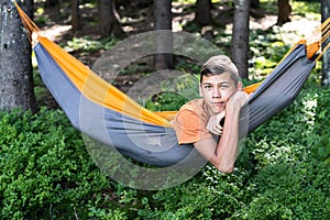 Teenager resting in a hammock. Relax during travel