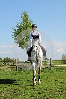 Teenager riding horse