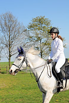 Teenager riding horse