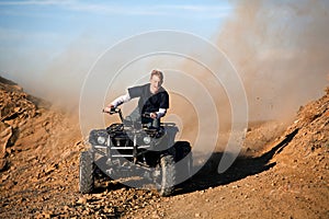 Teenager riding quad four wheeler