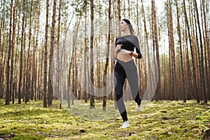 Teenager running in the woods. Pretty young girl runner in the forest. Jumping woman. Young lady running. Runner girl jogging