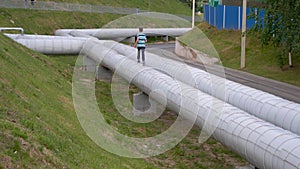 Teenager runs through the pipes of the heating main.