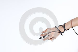 Teenager`s hand holds a computer mouse, wire around the wrist