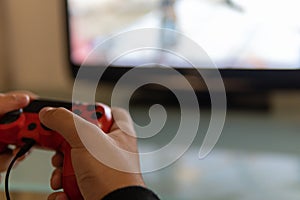 Teenager`s hands playing a console