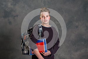 Teenager with satchel and books