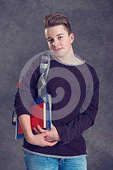 Teenager with satchel and books