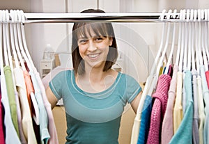 Teenager searching in closet for something to wear