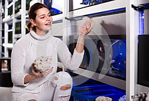 teenager selecting interesting aquarium rocks and stone for aquarium entourage