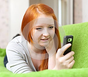 Teenager sends SMS on mobile