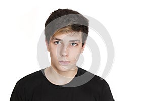 A teenager with a serious face and a black T-shirt on a white background