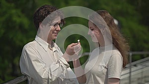 A teenager shares headphones with a girl